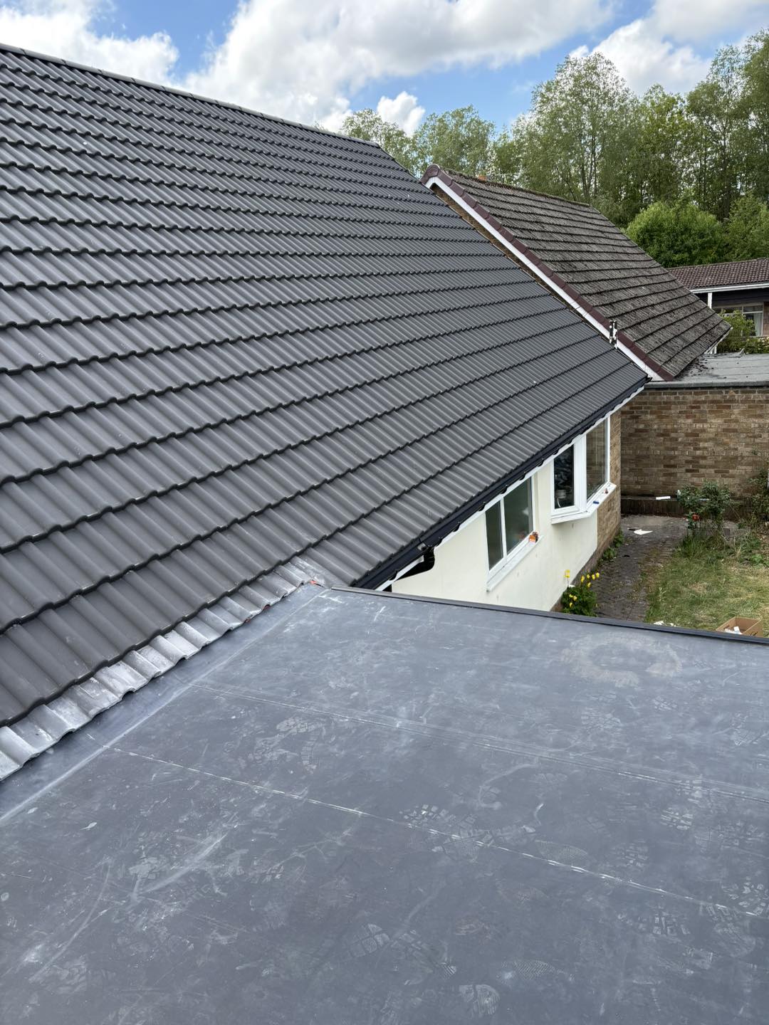 Completed dark tiled roof by SB Roofing Solutions